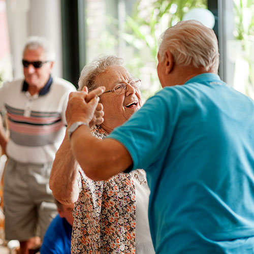 two senior citizens dancing